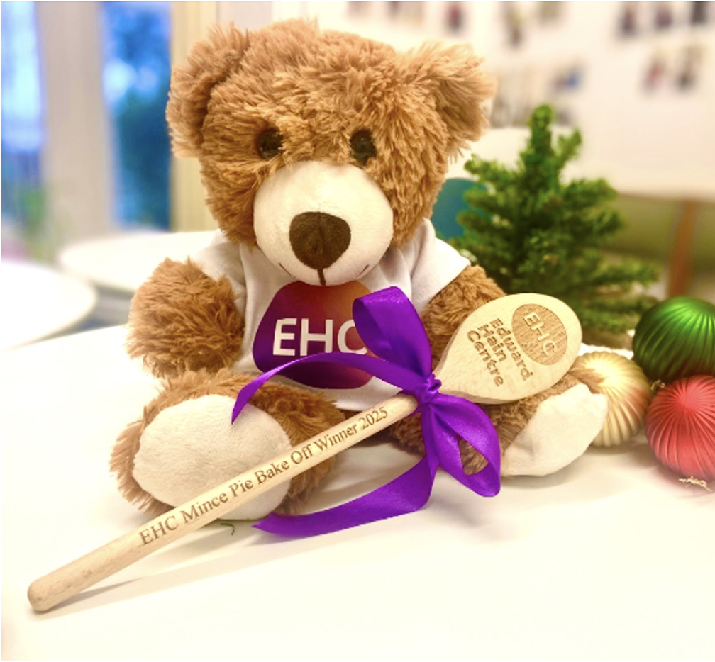 Teddy bear holding spoon