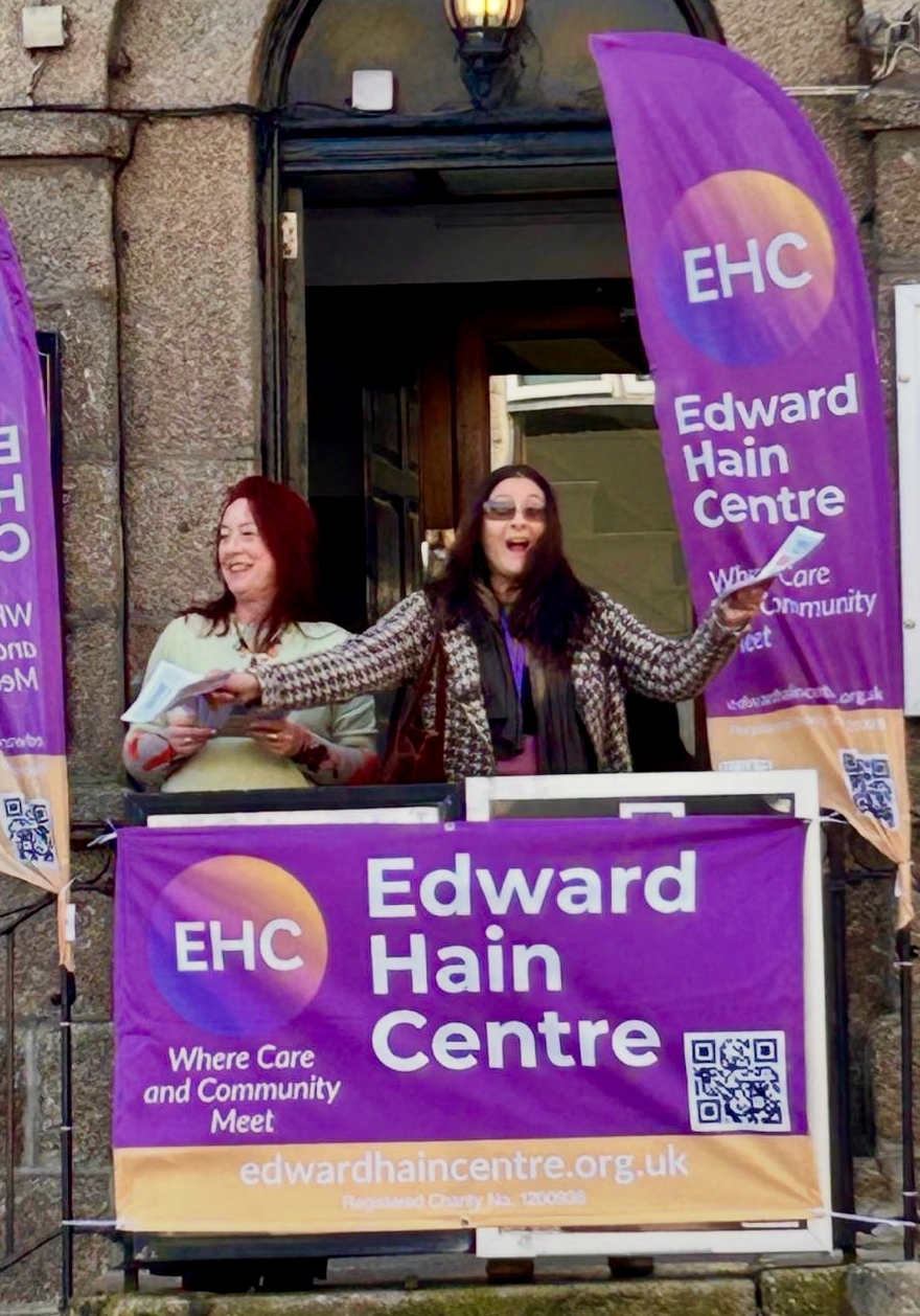 2 ladies laughing with Edward Hain Centre sail flags