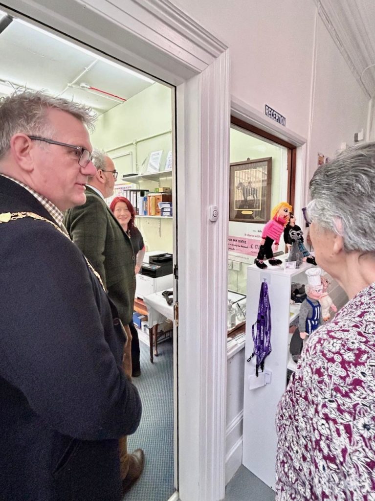 Group of people inside and outside an office