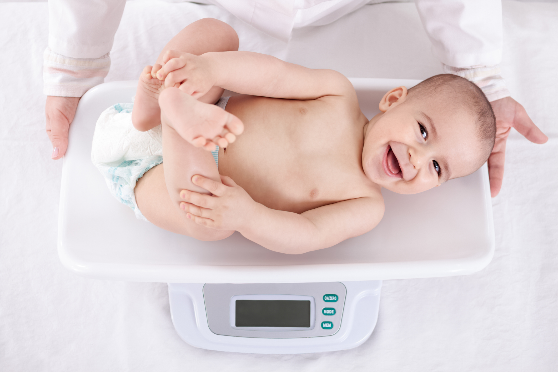 Baby being weighed and measured